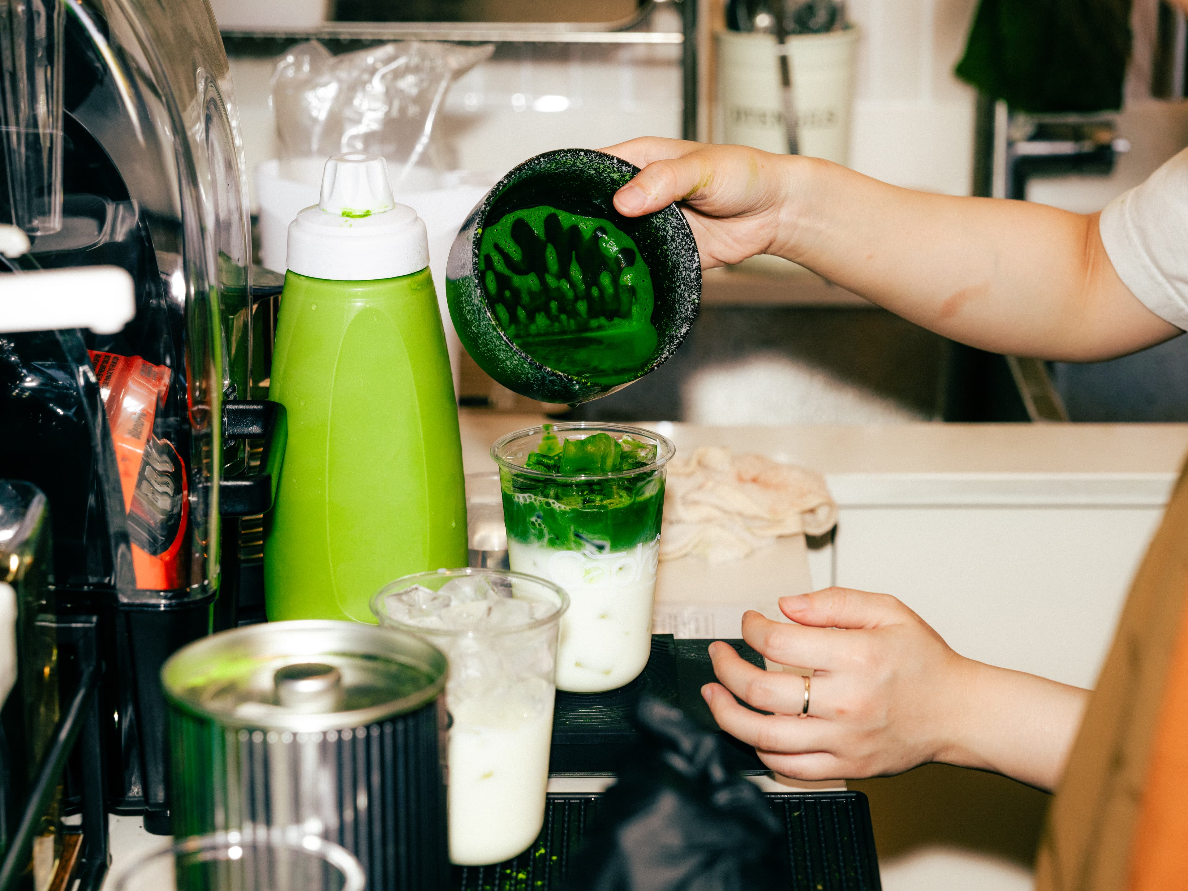 Close-up of hand whisking matcha